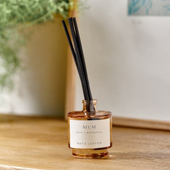 a bottle of perfume sitting on top of a wooden table