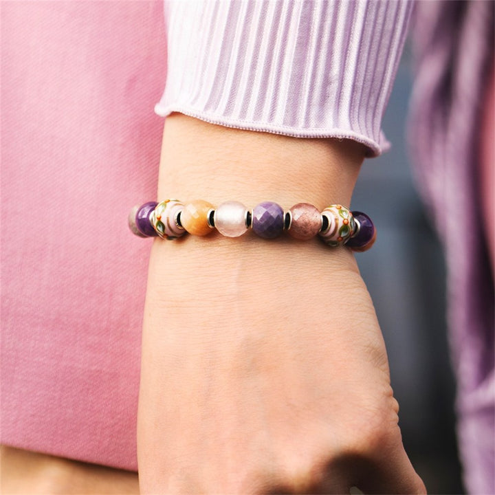 Multicolored beaded bracelet on a wrist with a blurred background