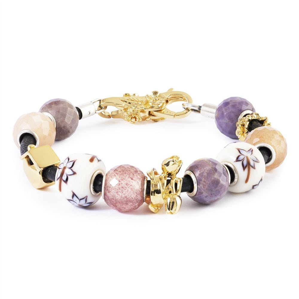 Multicolored beaded bracelet with gold accents on a white background