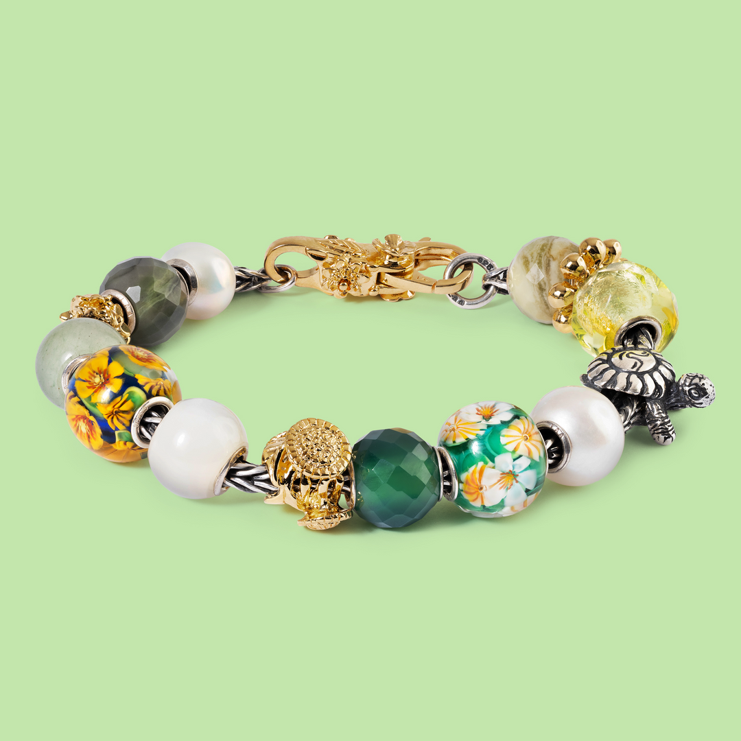 Multicolored beaded bracelet with floral designs on a light green background
