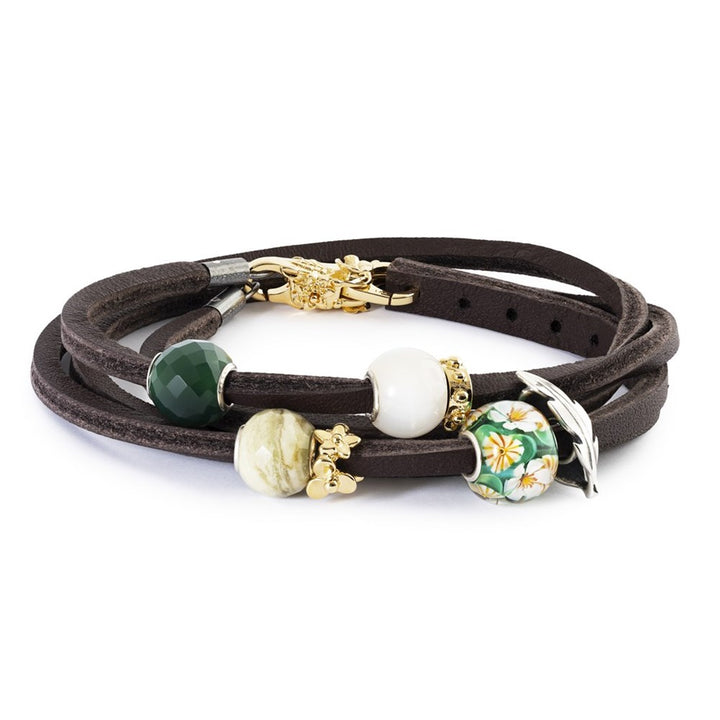 Brown leather bracelet with various beads on a white background