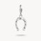 Silver horseshoe charm with embedded stones on a white background
