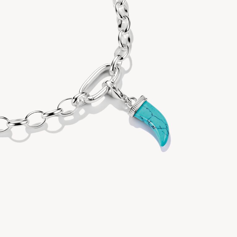 Silver bracelet with a turquoise charm on a white background