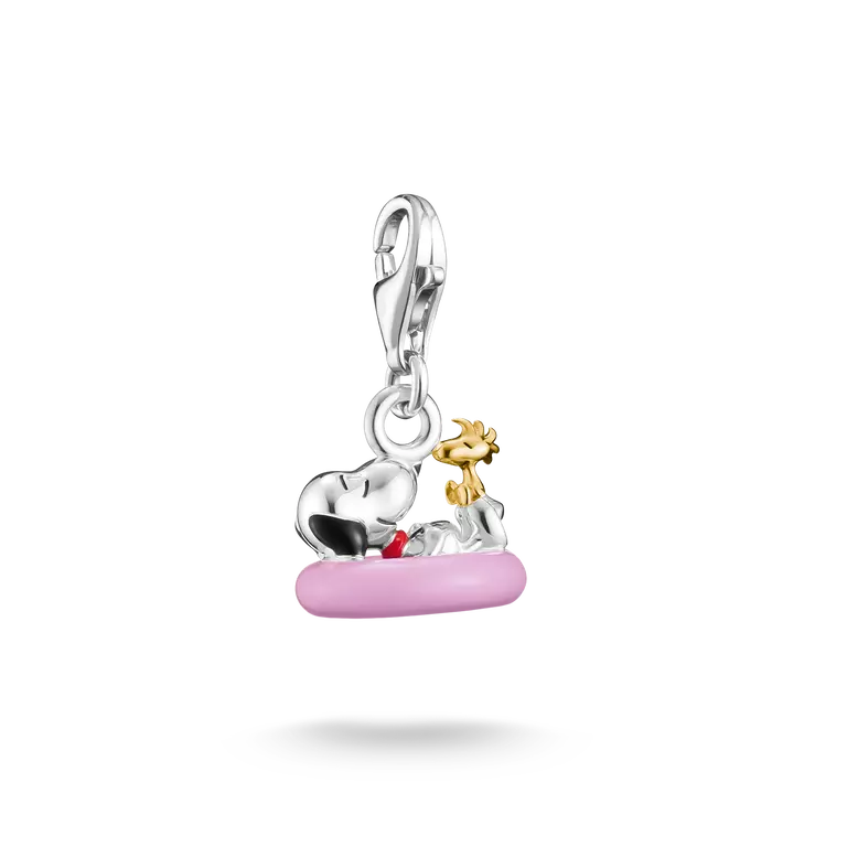 Silver and gold charm with pink base on a white background