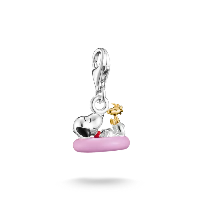 Silver and gold charm with pink base on a white background