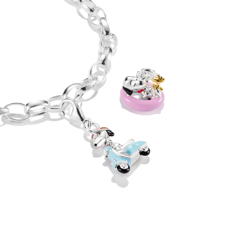 Silver bracelet with two charms on a white background