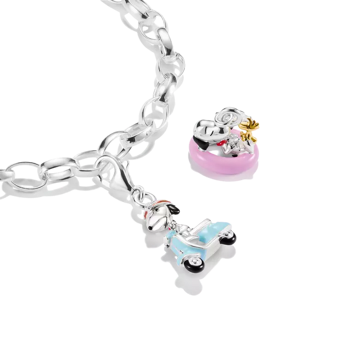 Silver bracelet with two charms on a white background