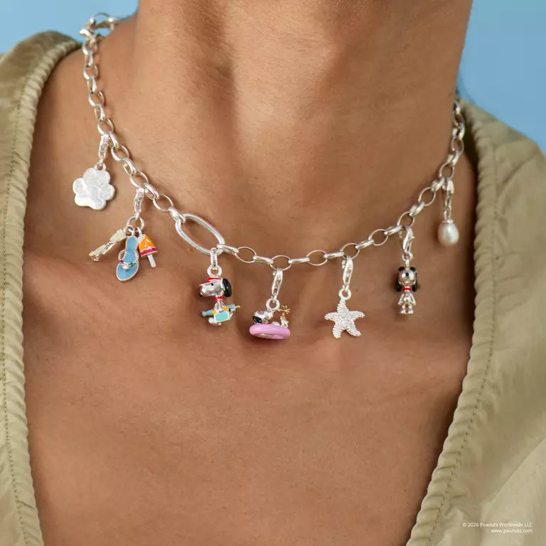 Necklace with various charms worn by a person against a blue background