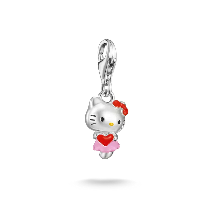 A silver Hello Kitty charm pendant featuring a silver cat head with a red bow, holding a red heart, wearing a pink skirt, and attached to a silver lobster clasp, shown on a white background with a soft shadow.