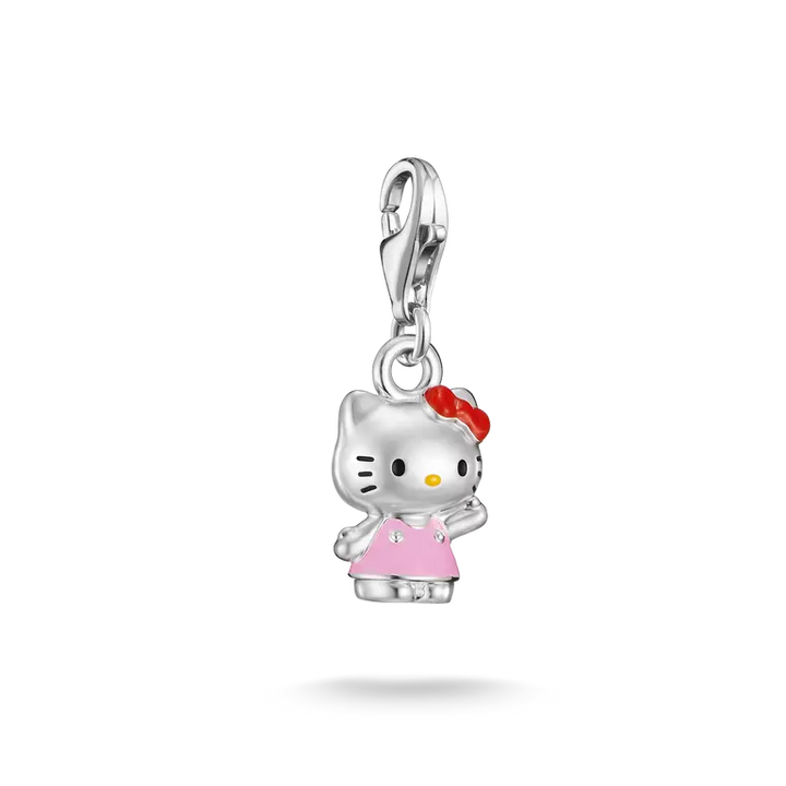 A silver Hello Kitty charm pendant featuring a silver body, pink dress, red bow, and yellow nose, suspended from a silver lobster clasp on a white background.