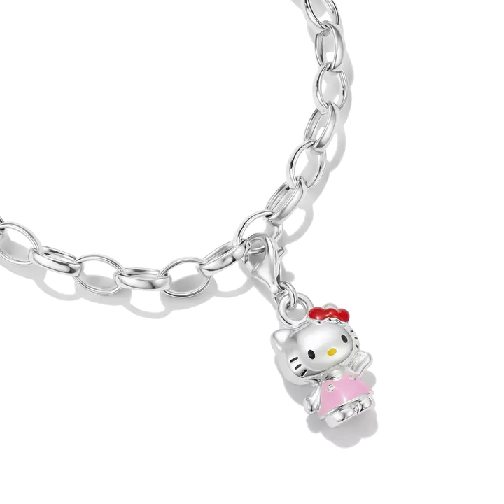 A silver link chain bracelet featuring a Hello Kitty charm wearing a pink dress and red bow, shown on a clean white background.
