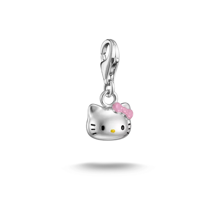 A silver Hello Kitty charm pendant with a pink bow and yellow nose, suspended against a plain white background.