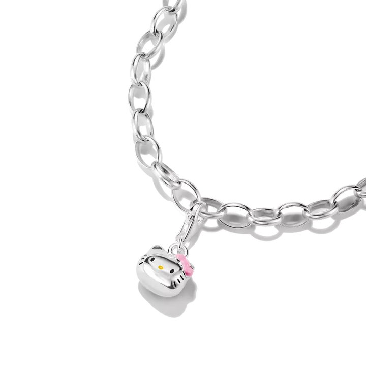 A silver link chain bracelet featuring a Hello Kitty face charm with a pink bow, shown on a clean white background.