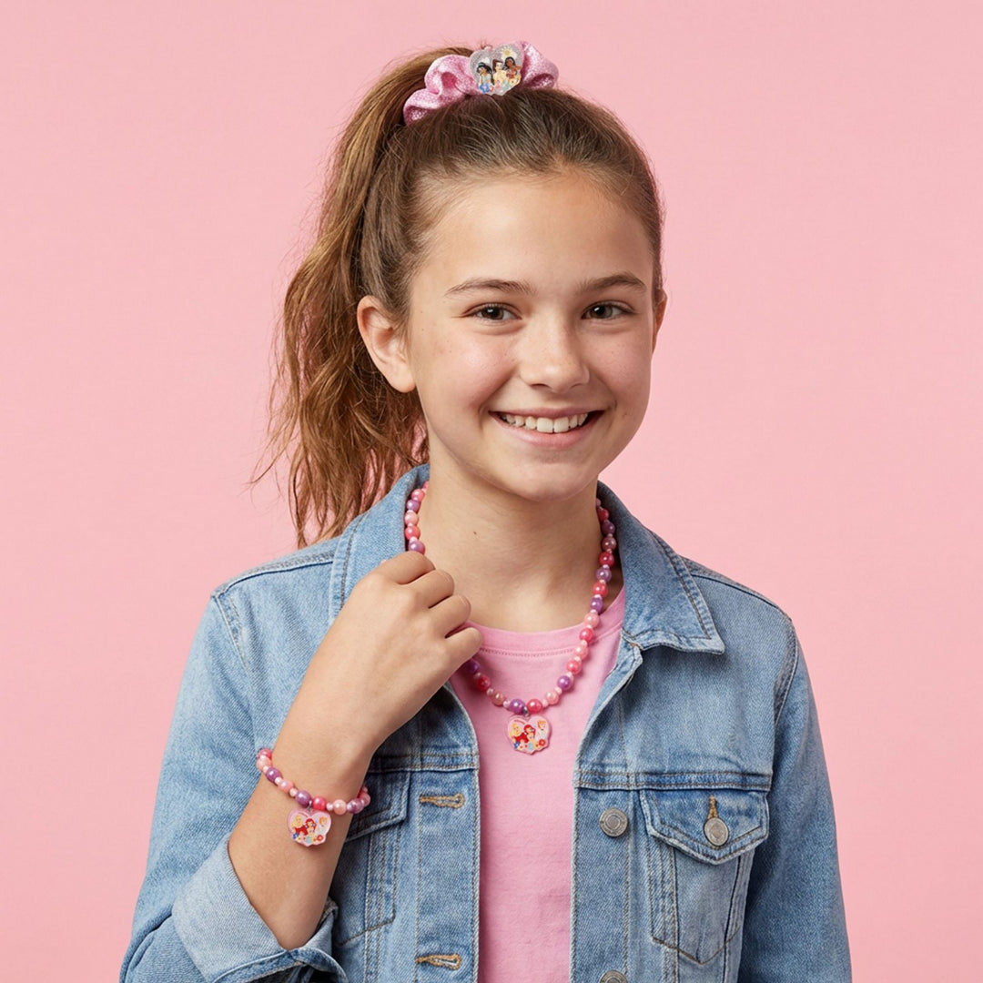 Young girl wearing a denim jacket and pink accessories on a pink background