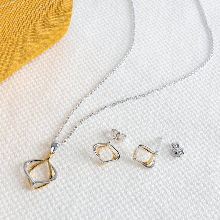 Jewelry set with a necklace and earrings on a textured surface