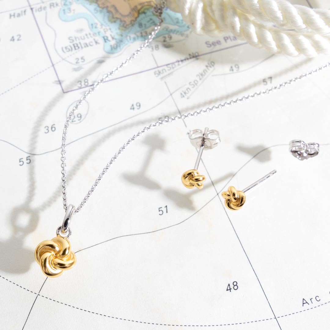 Gold and silver jewelry on a map background