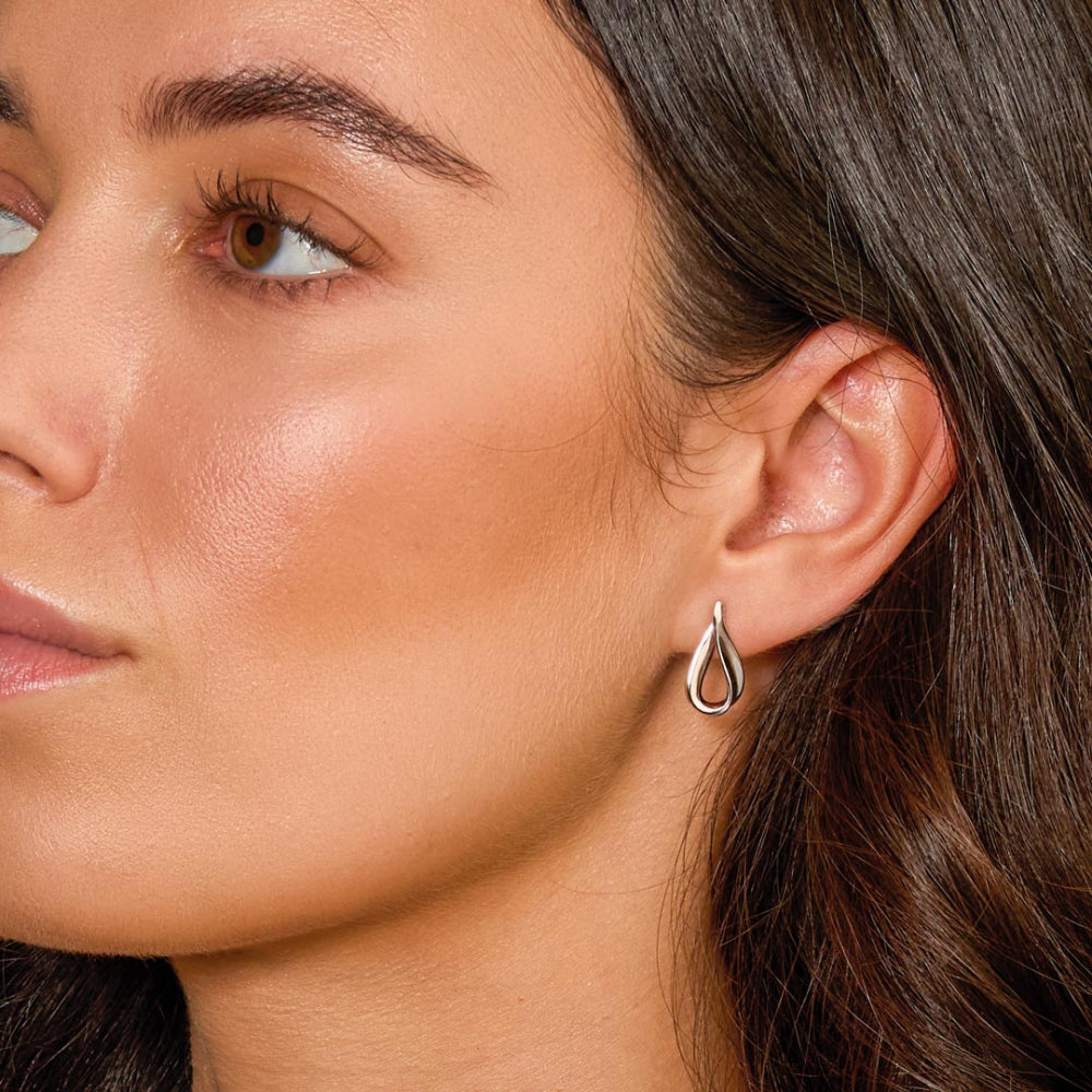 Close-up of a woman wearing a silver earring.