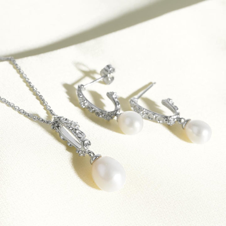 Pearl necklace and earrings on a white background