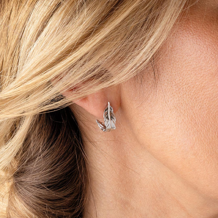 Silver hoop earring worn by a person with blonde hair.