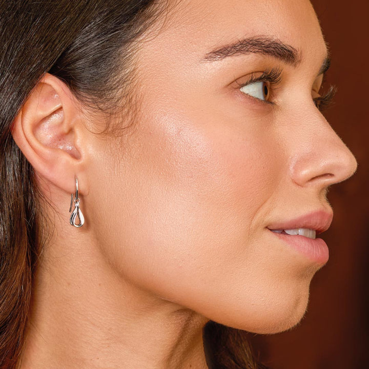 Close-up of a woman's profile with a focus on her earring.