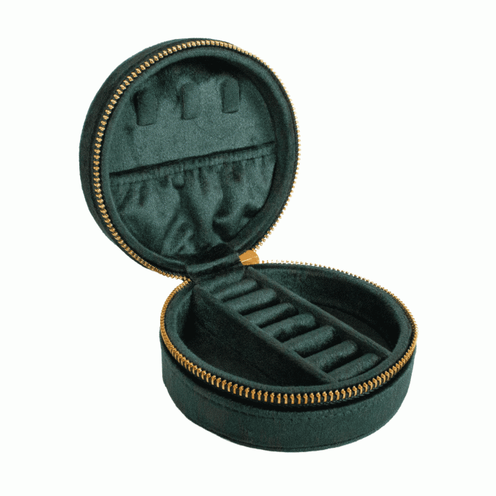 An open round dark green velvet jewelry case with gold-tone zippers and an interior organizer tray, shown on a plain white background.