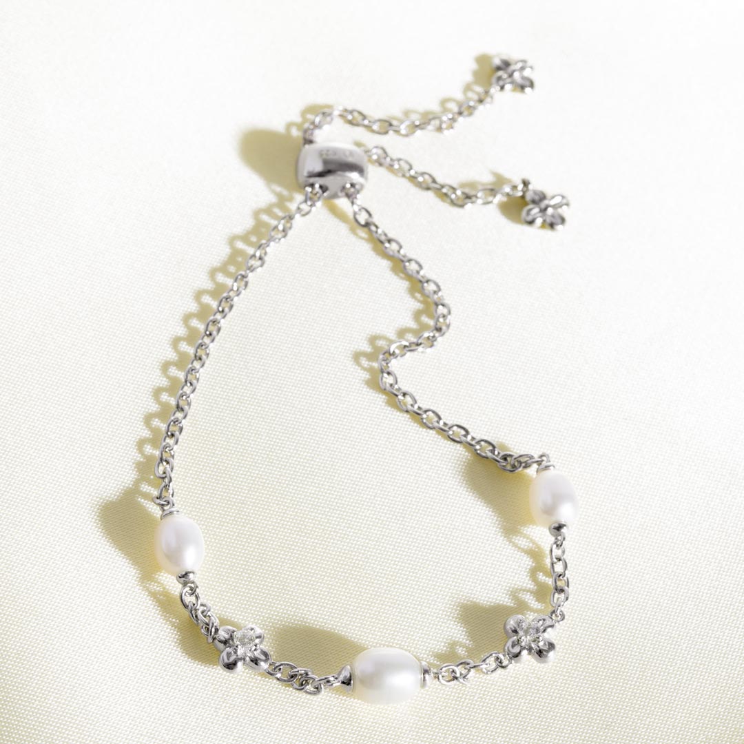 Silver bracelet with pearls on a light background