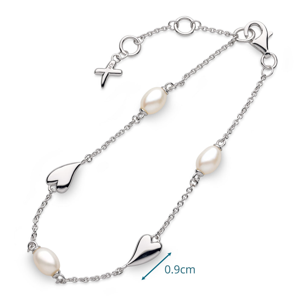 Silver bracelet with heart-shaped links and pearls on a white background