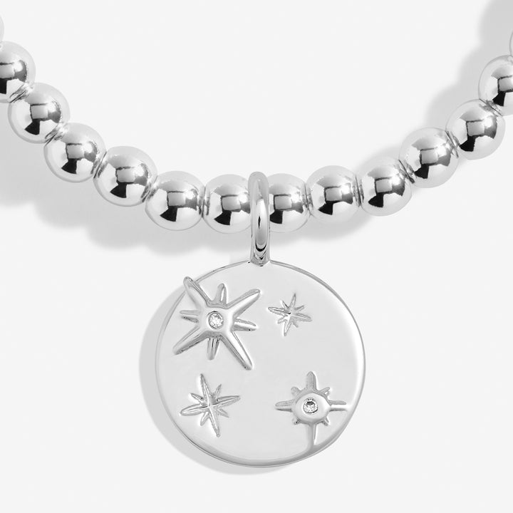 a silver beaded necklace with a star charm