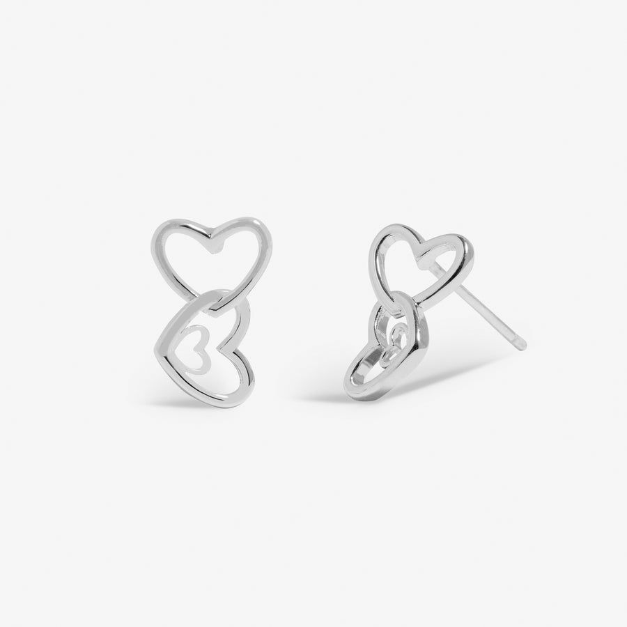 a pair of heart shaped earrings on a white background