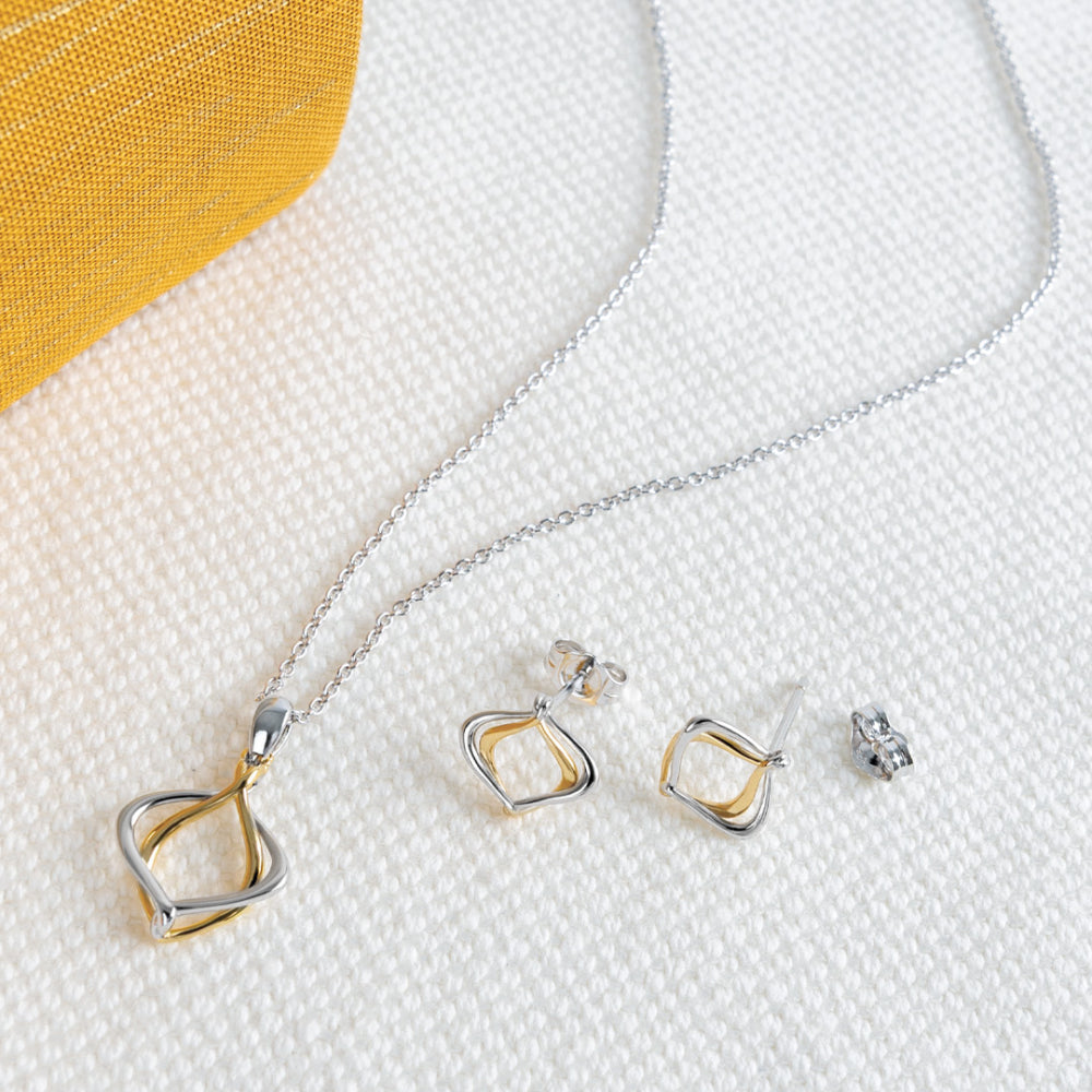 Jewelry set with a necklace and earrings on a textured surface