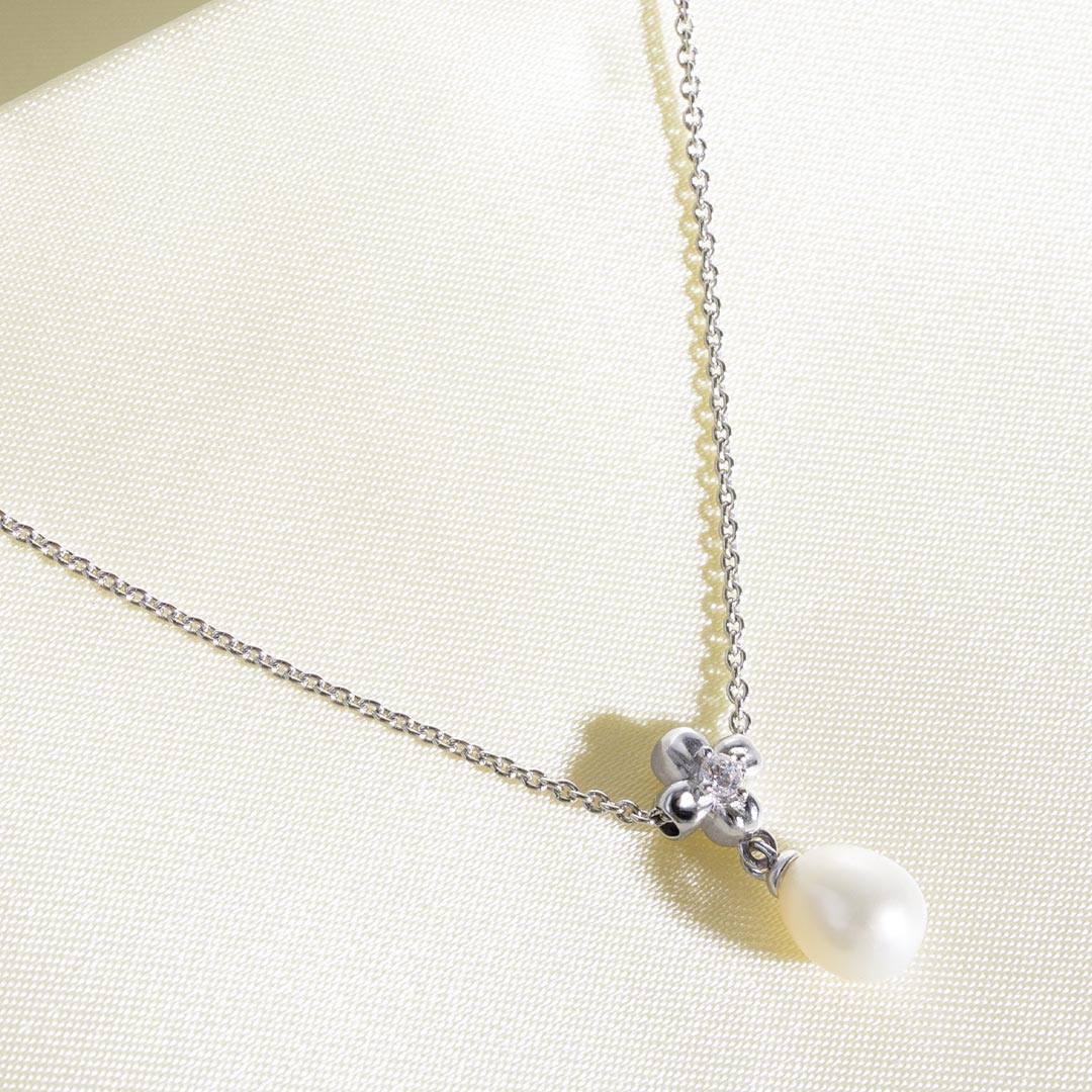 Necklace with a pearl pendant on a light background