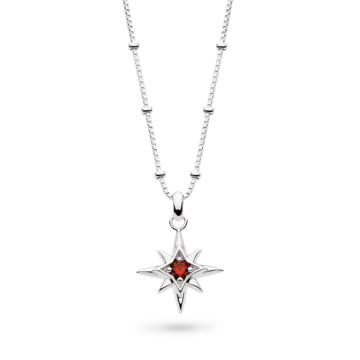 Silver necklace with a star-shaped pendant featuring a red gemstone on a white background