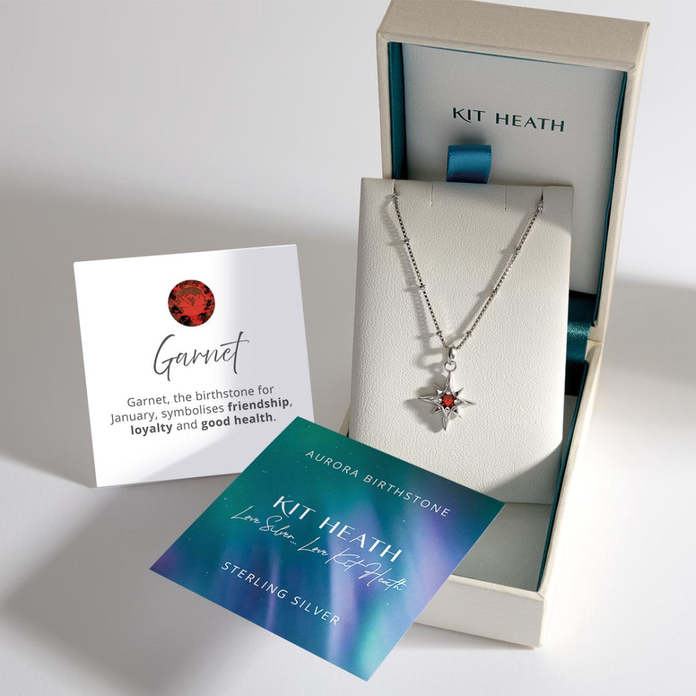 Kit Heath garnet necklace in a box with information card on a white background