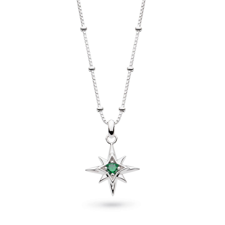 Silver necklace with a star-shaped pendant featuring a green gemstone on a white background