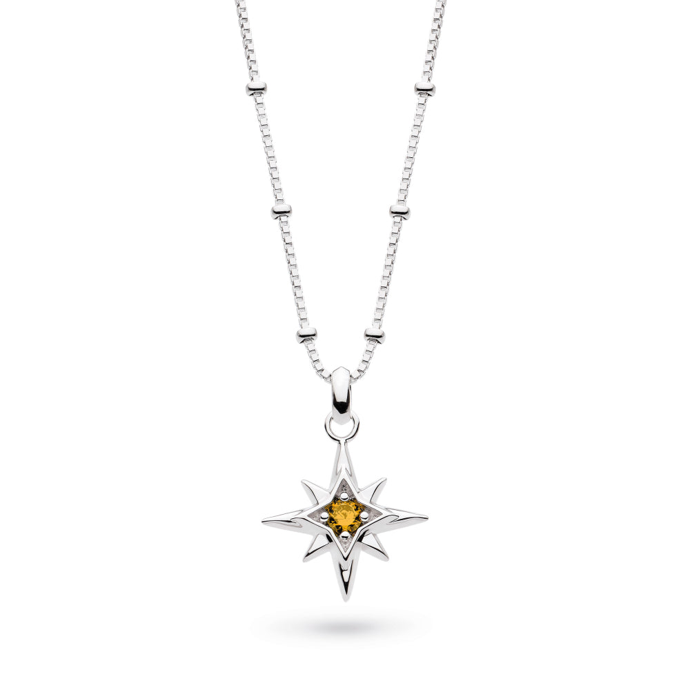 Silver necklace with a star-shaped pendant featuring a yellow gemstone on a white background