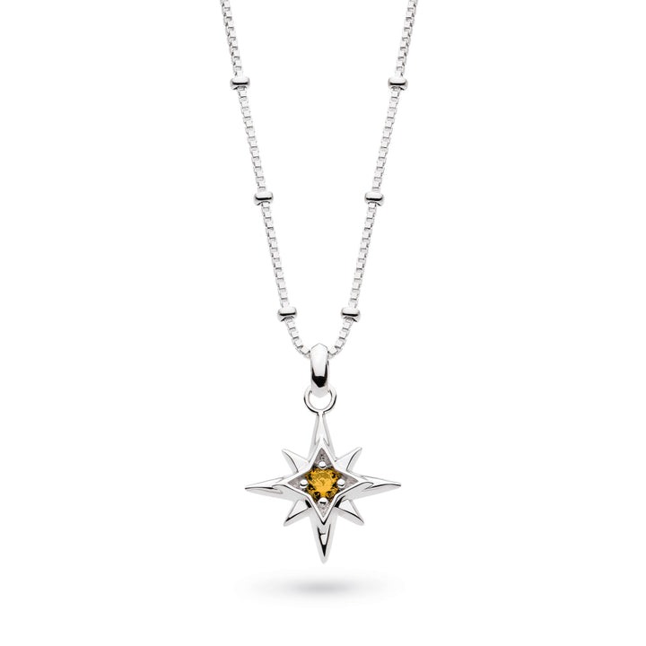 Silver necklace with a star-shaped pendant featuring a yellow gemstone on a white background