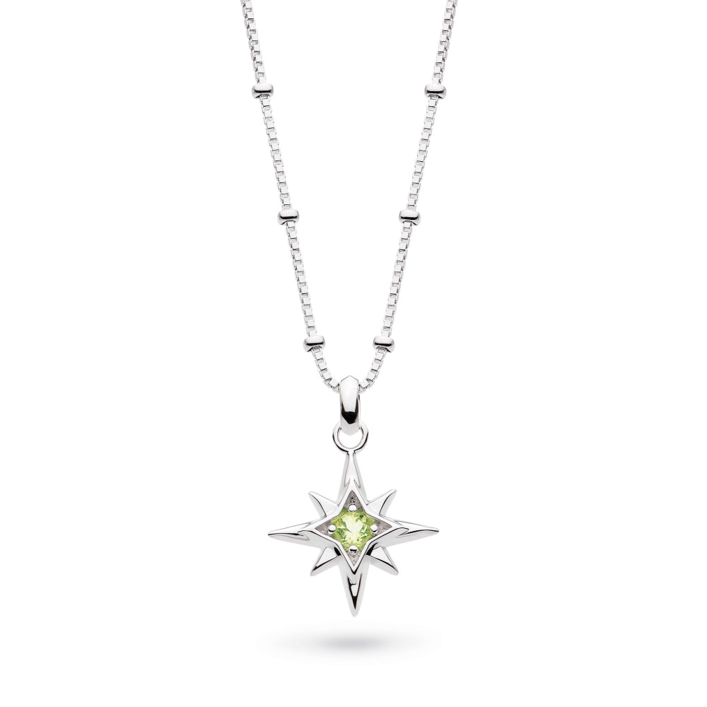 Silver necklace with a star-shaped pendant featuring a green gemstone on a white background