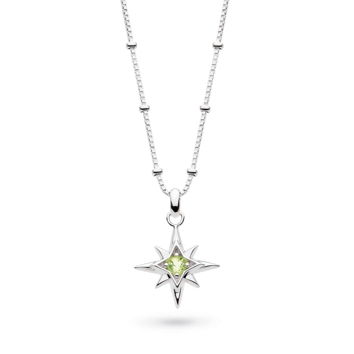 Silver necklace with a star-shaped pendant featuring a green gemstone on a white background