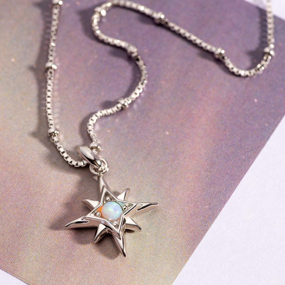 Silver necklace with a star-shaped pendant on a gradient background