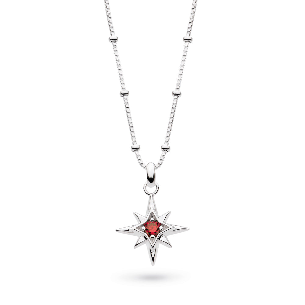 Silver necklace with a star-shaped pendant featuring a red gemstone on a white background
