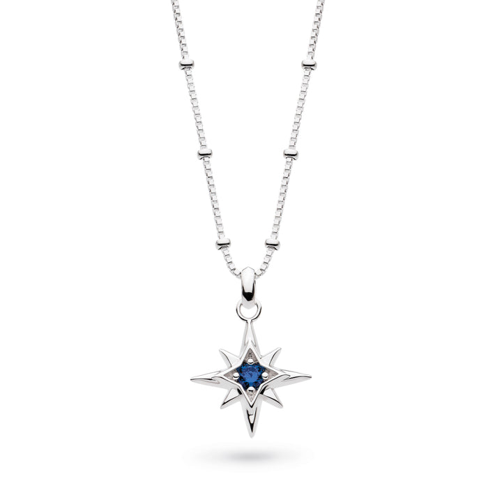 Silver necklace with a star-shaped pendant featuring a blue gemstone on a white background
