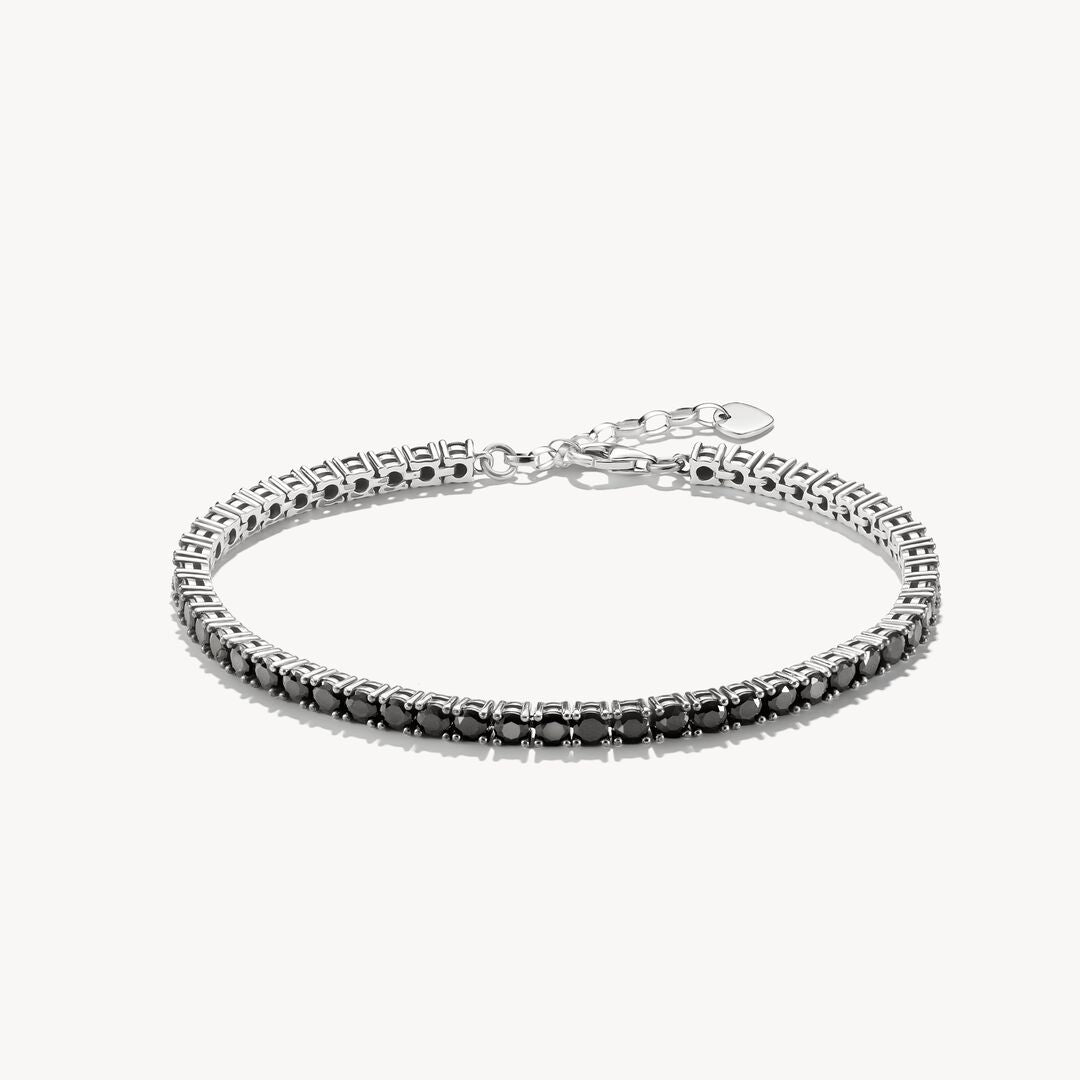 Silver bracelet with black stones on a white background