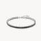 Silver bracelet with black stones on a white background