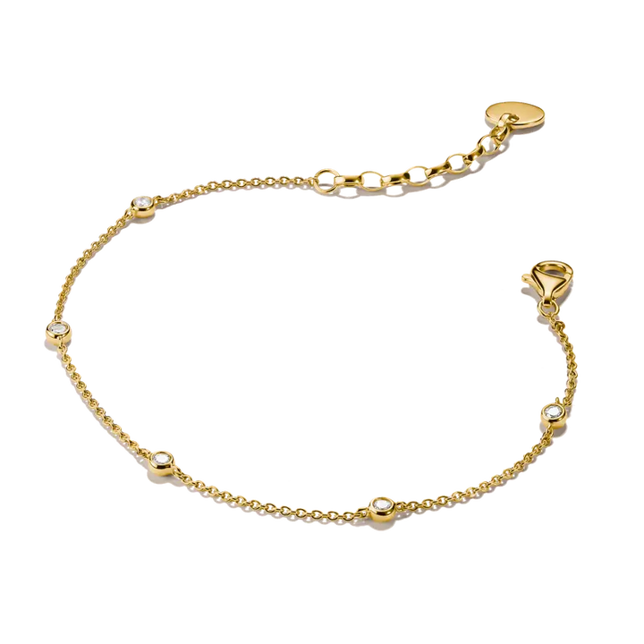 A delicate gold chain bracelet with small bezel-set clear stones spaced along the chain, featuring a lobster clasp and an adjustable extension link section with a round tag, shown on a plain white background.