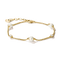 A delicate gold chain bracelet featuring three white pearl beads and two small clear crystal accents, displayed on a clean white background.