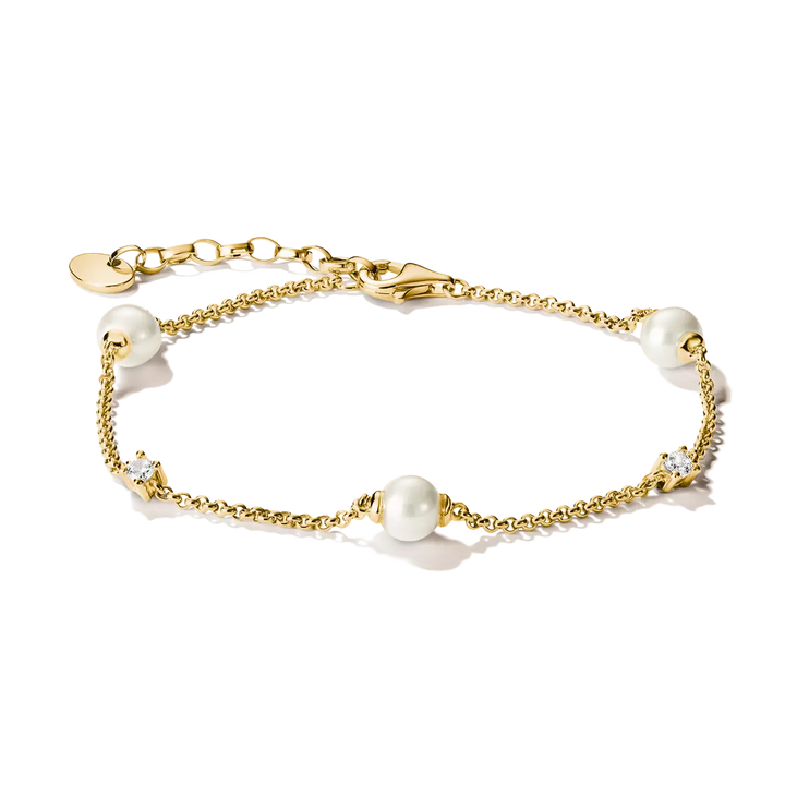 A delicate gold chain bracelet featuring three white pearl beads and two small clear crystal accents, displayed on a clean white background.