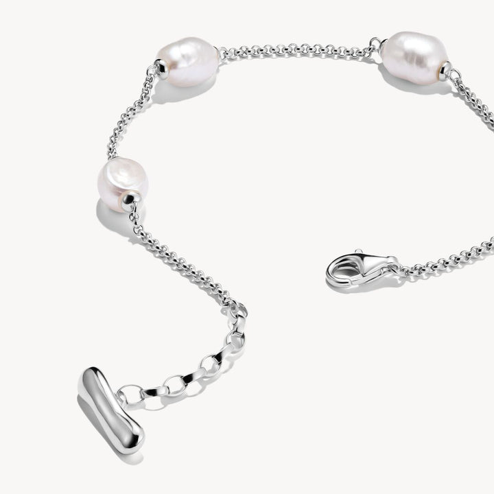 Silver bracelet with pearls on a white background