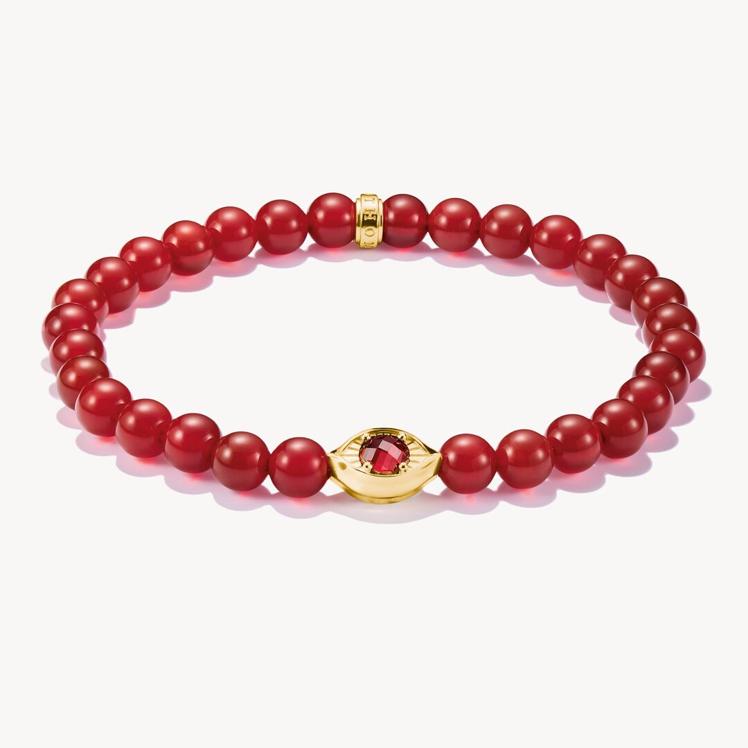 Red beaded bracelet with gold clasp on a white background