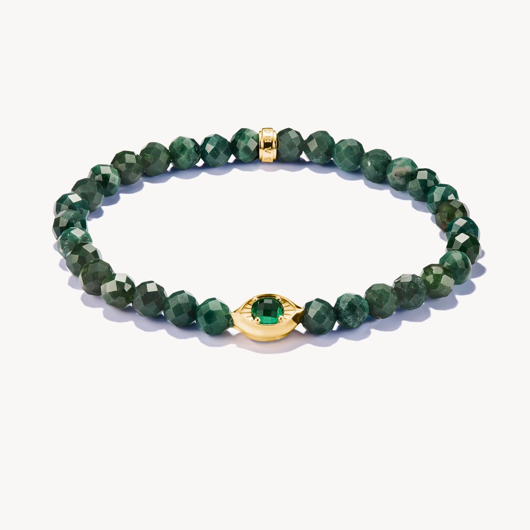 Green beaded bracelet with gold accents on a white background