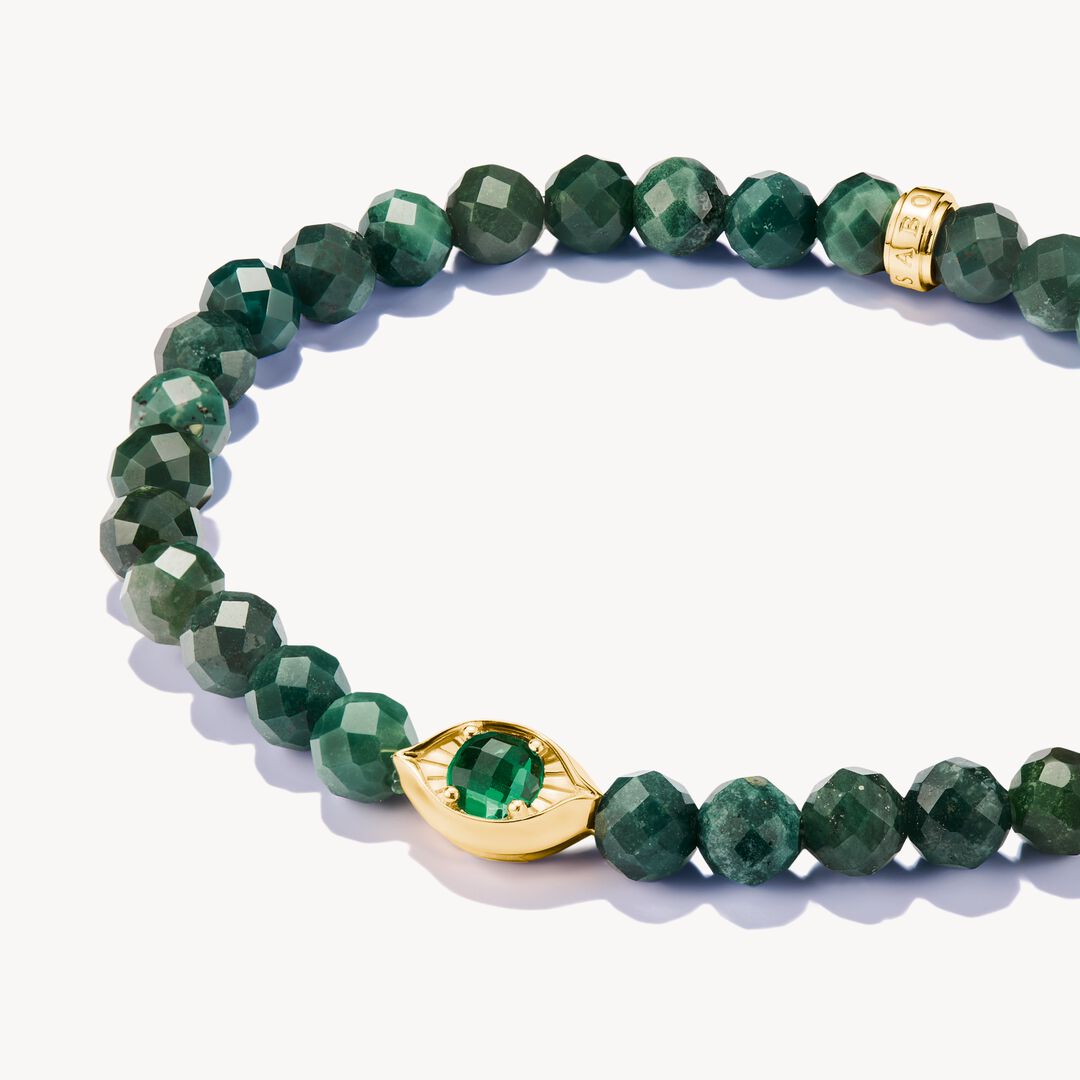 Green beaded bracelet with a gold clasp on a white background